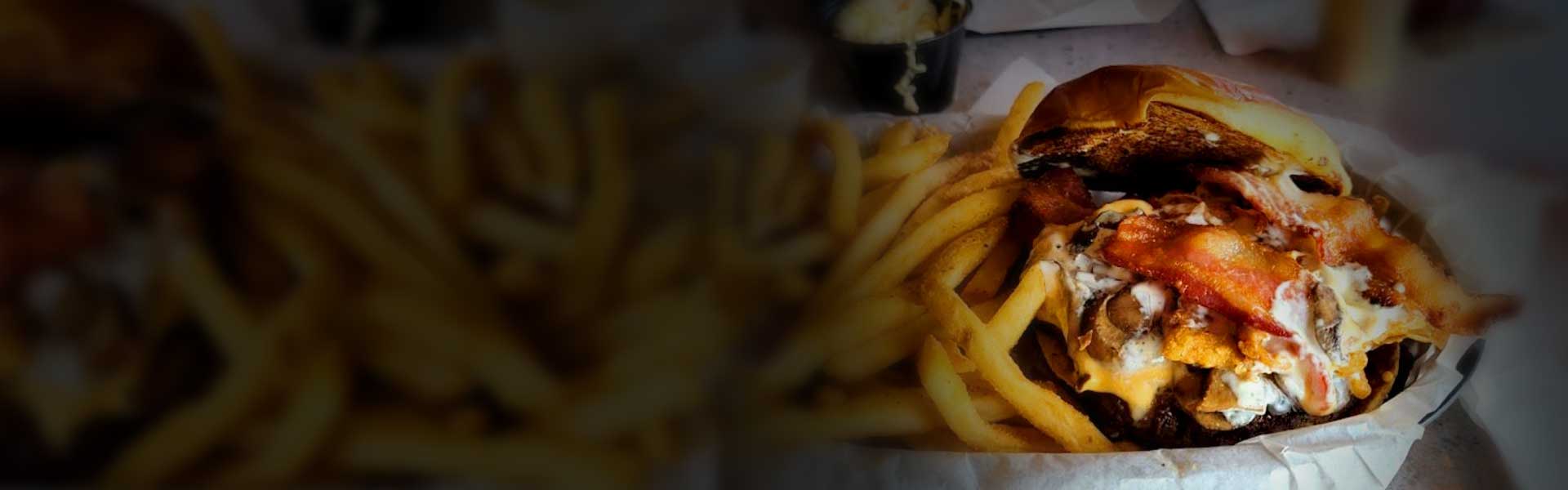 Bacon cheeseburger and fries at Mo's Pub