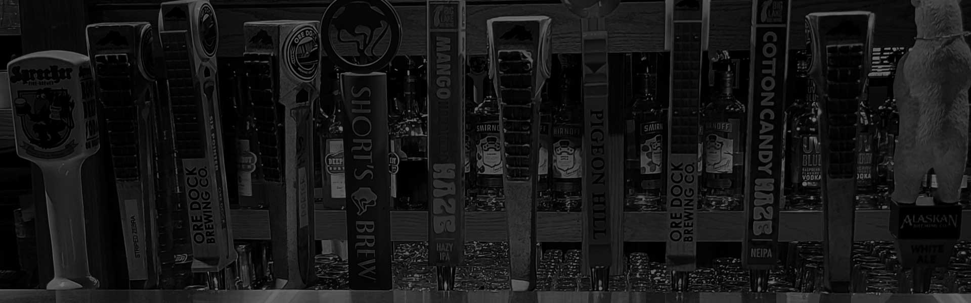 Colorful beer tap handles line the bar at Mo's Pub